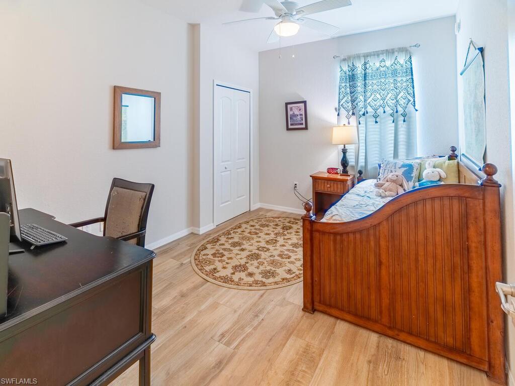 Bedroom with light hardwood / wood-style floors and ceiling fan