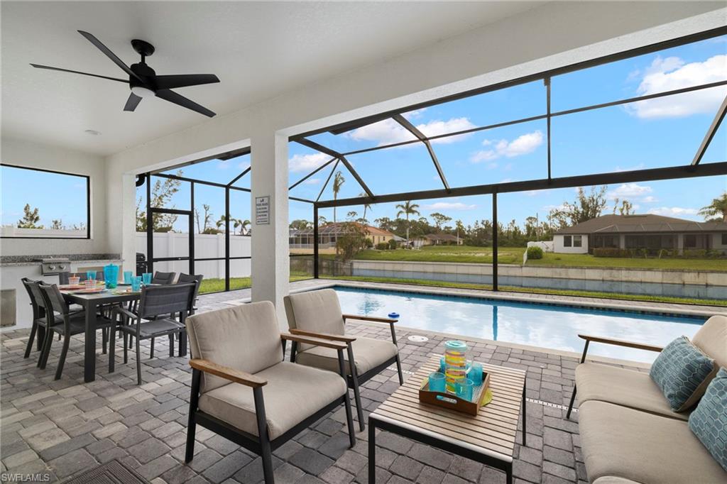 View of patio / terrace with ceiling fan, a fenced in pool, and a lanai