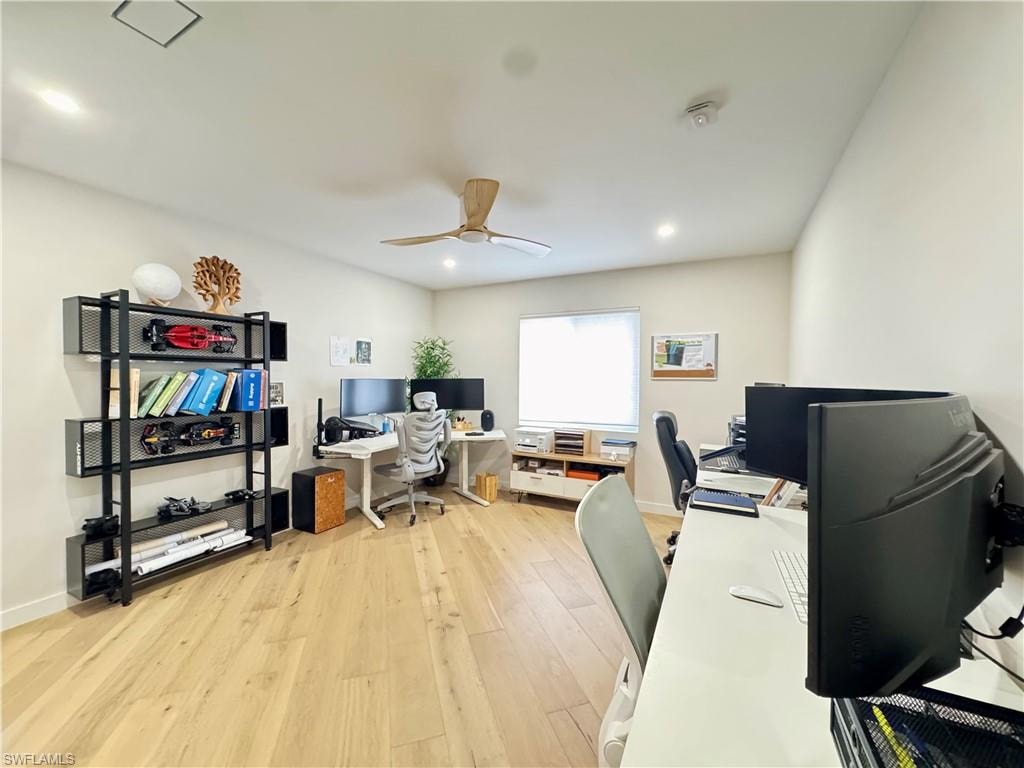 Office area featuring light wood-type flooring, ceiling fan, and recessed lighting
