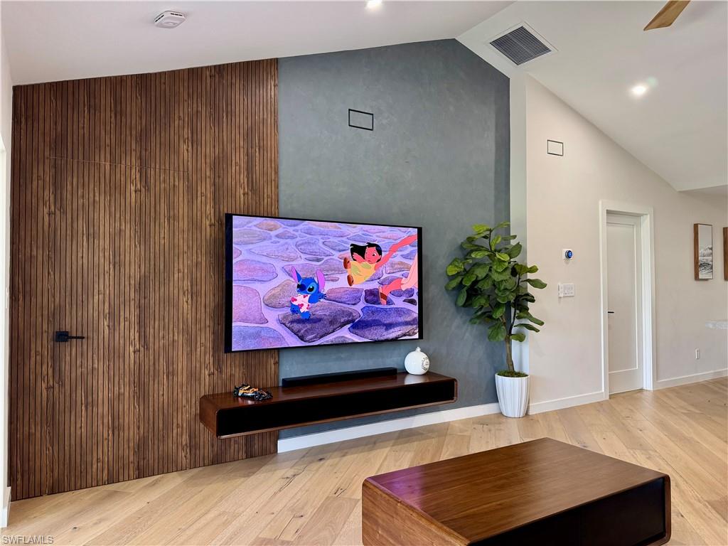 Living area with wood finished floors and lofted ceiling