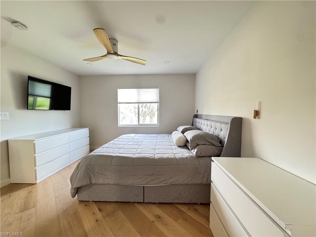 Bedroom with light wood-type flooring and ceiling fan