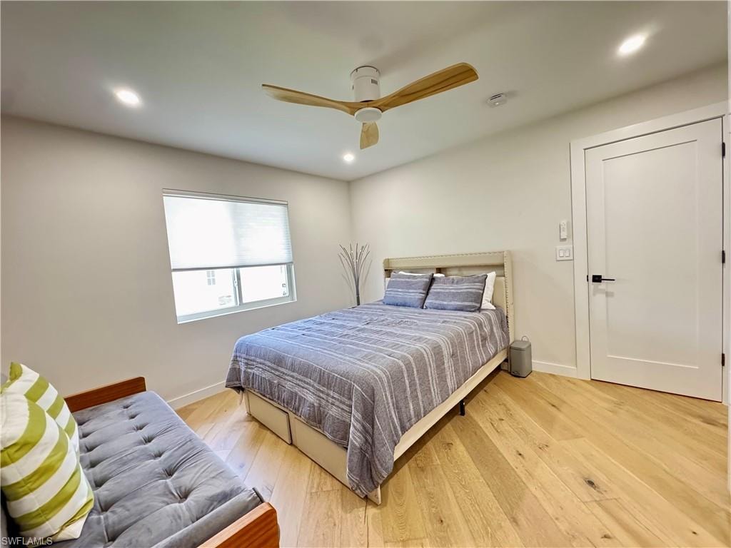 Bedroom featuring light wood-type flooring, baseboards, recessed lighting, and a ceiling fan