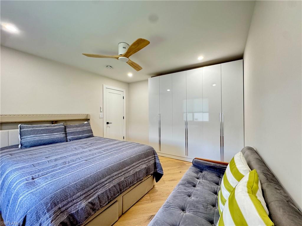Bedroom with light wood-type flooring, recessed lighting, and ceiling fan