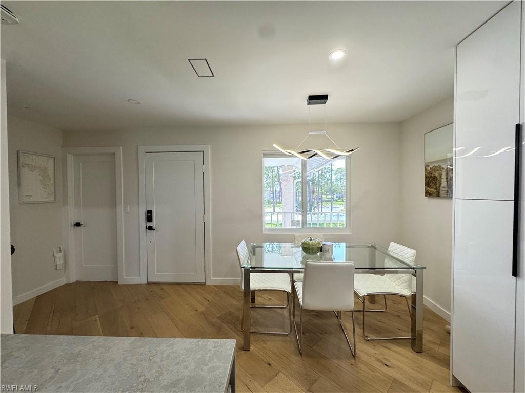 Dining space featuring light wood-style flooring, baseboards, and recessed lighting