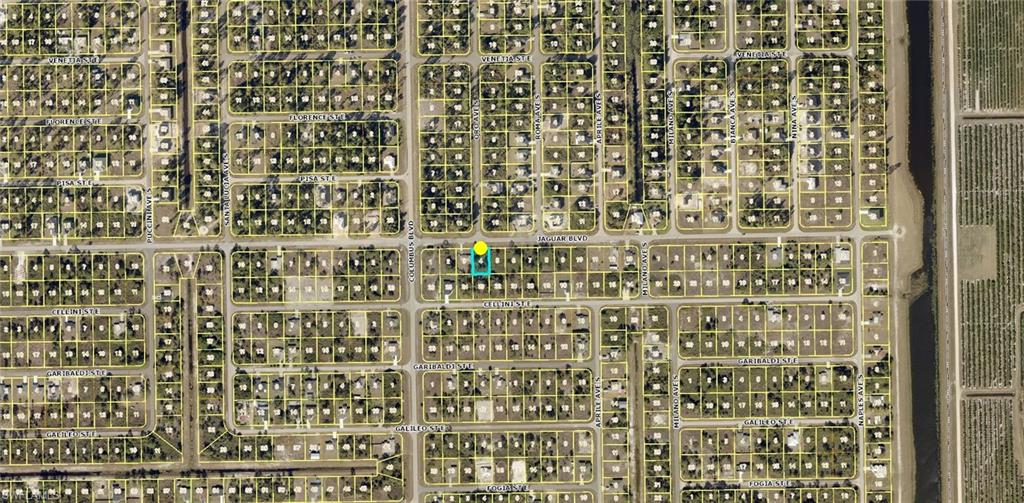 Aerial Map. Illustrating the property's location within a residential grid and its proximity to a canal and agricultural area