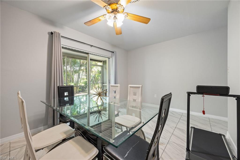 Dining room sliding glass doors opening to a screened enclosure