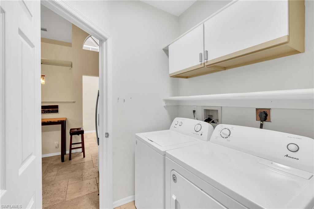Dedicated laundry area featuring a white washing machine and dryer