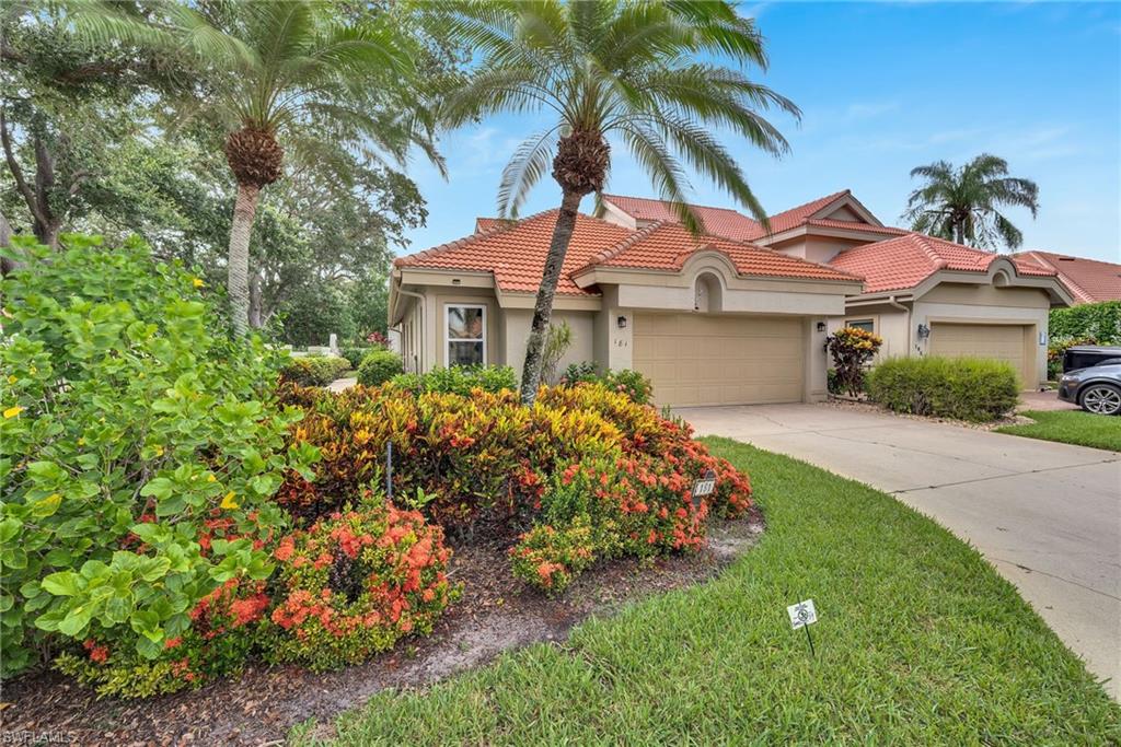 Front exterior with a tile roof and beige stucco finish