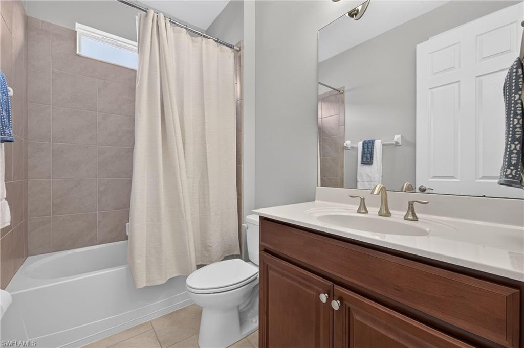 Bathroom vanity with a white countertop and undermount sink, complemented by a brushed nickel faucet