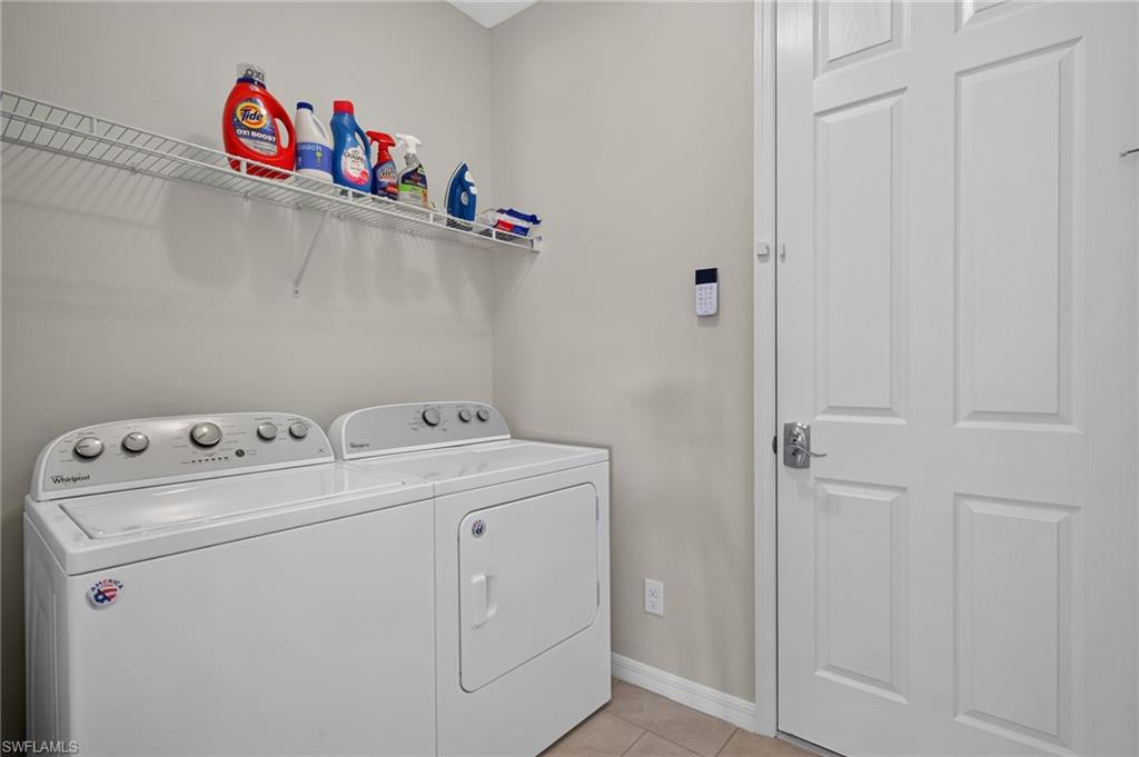 Dedicated laundry space featuring a white wire shelving unit