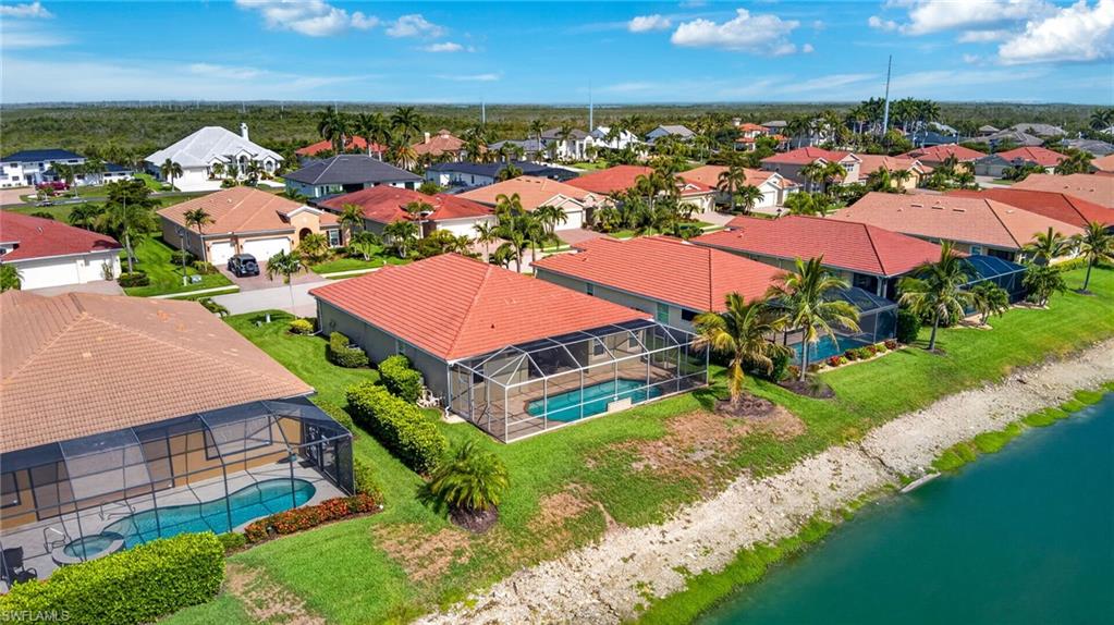 Aerial perspective of a residential community featuring multiple properties with screened pools