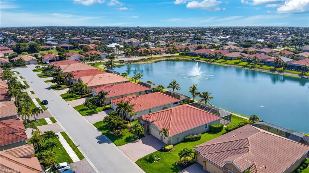 Aerial perspective showcasing a residential area with a prominent central lake featuring a fountain