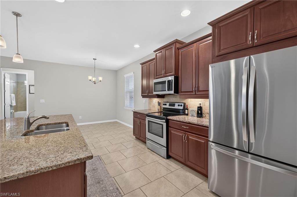 Kitchen featuring a stainless steel French door refrigerator, built-in microwave, and electric range