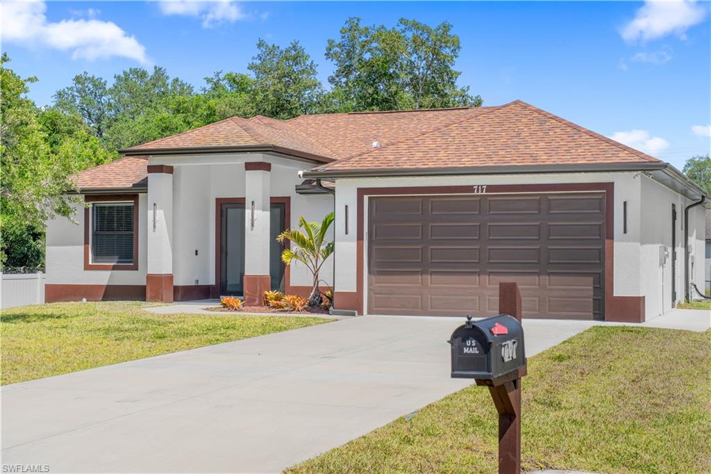 Contemporary exterior with white stucco and brown trim accents