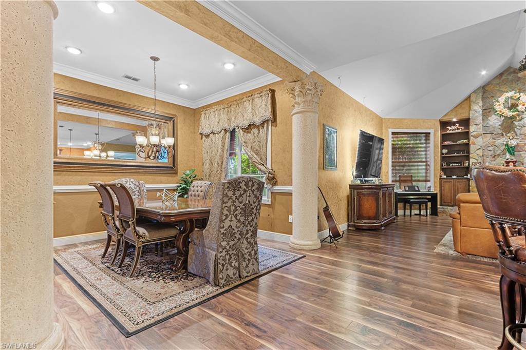 Formal dining area with wood-finish flooring and textured wall finishes