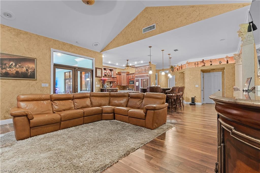 Spacious living area featuring wood-finish flooring and a textured wall finish