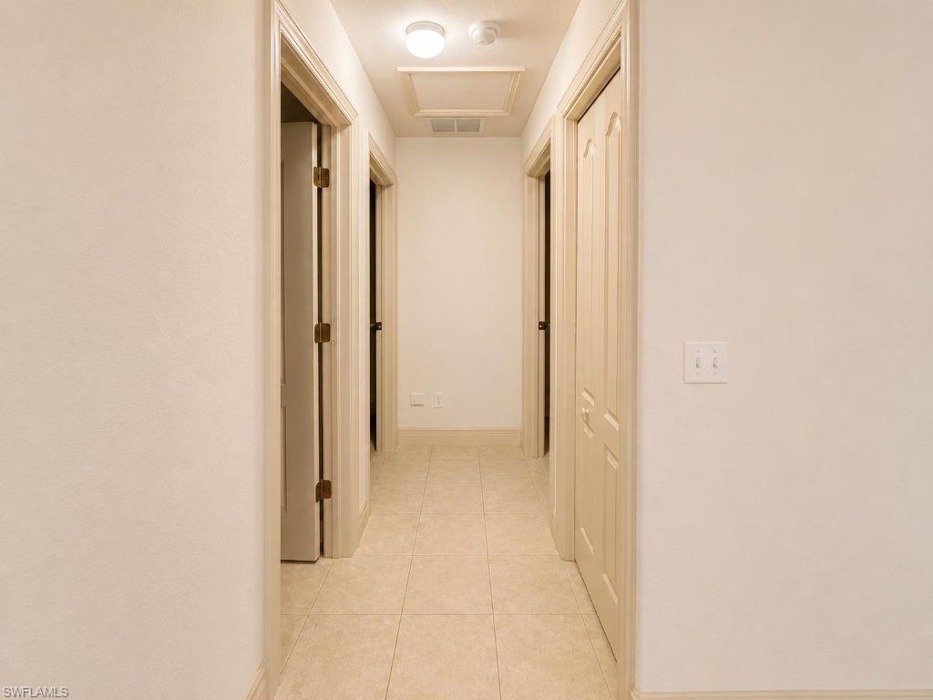 Hallway featuring tiled flooring, recessed ceiling light, and flush-mounted ceiling light