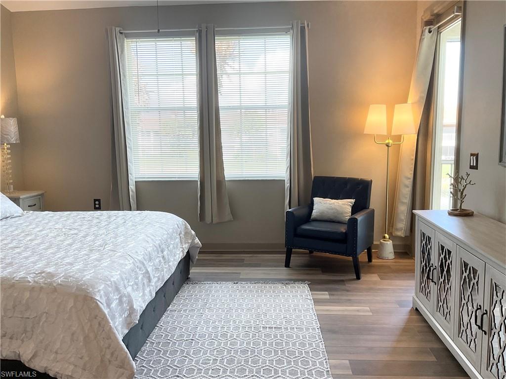 Primary bedroom overlooks the lake and opens to lanai area