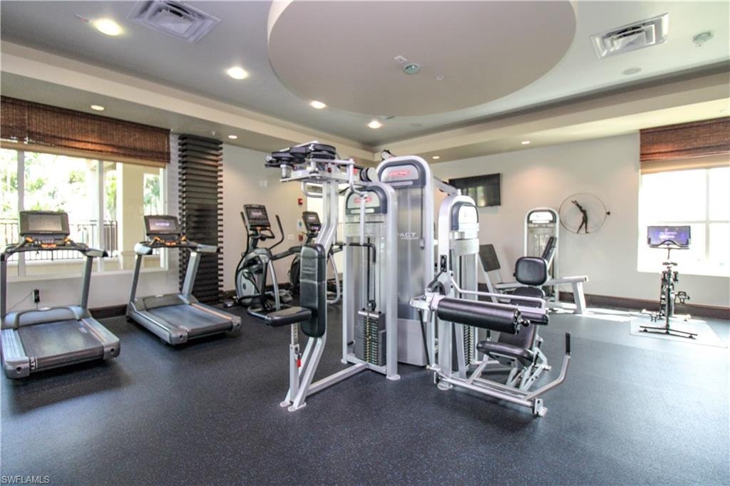 Workout area featuring a tray ceiling
