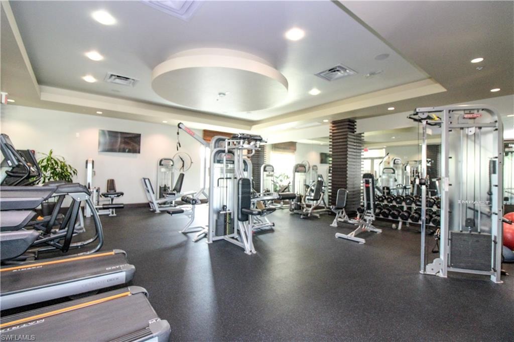Exercise room featuring a tray ceiling