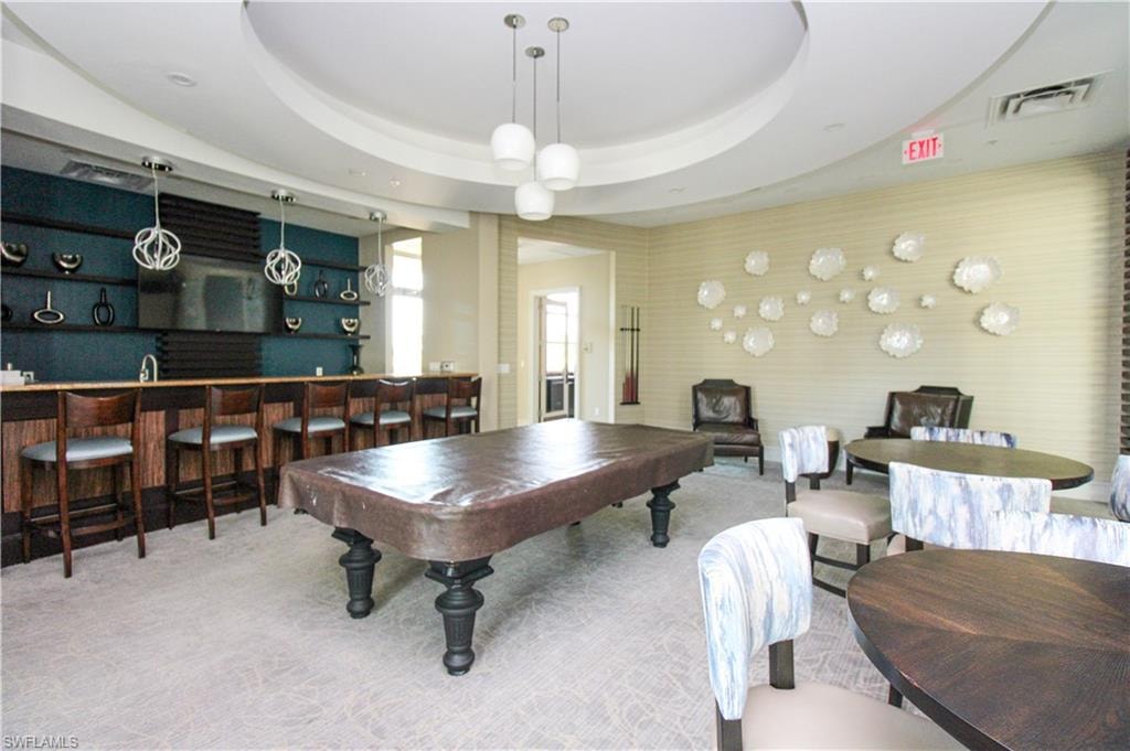 Rec room featuring carpet flooring, bar area, billiards, and a raised ceiling