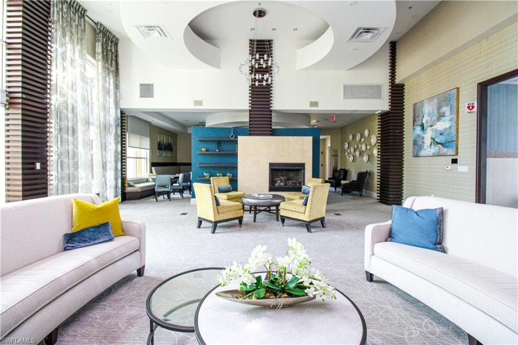Carpeted living room with a high ceiling