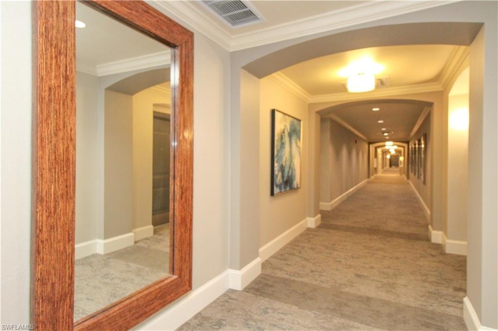 Corridor with ornamental molding and carpet floors