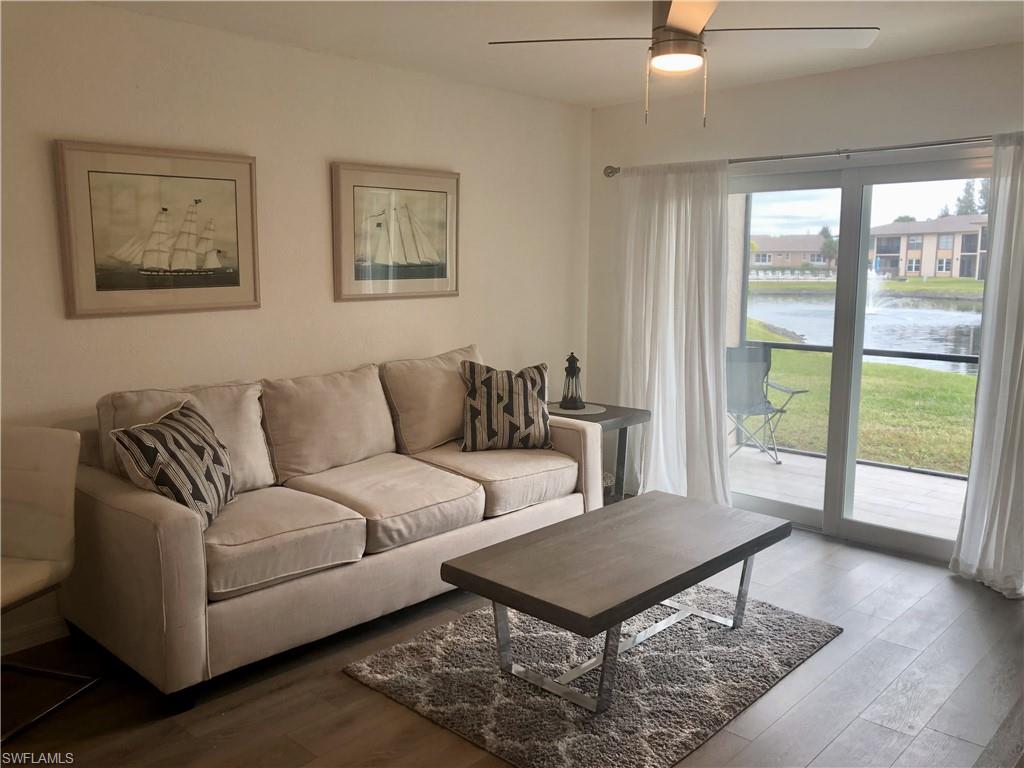 Living area with light-toned wood-finish flooring