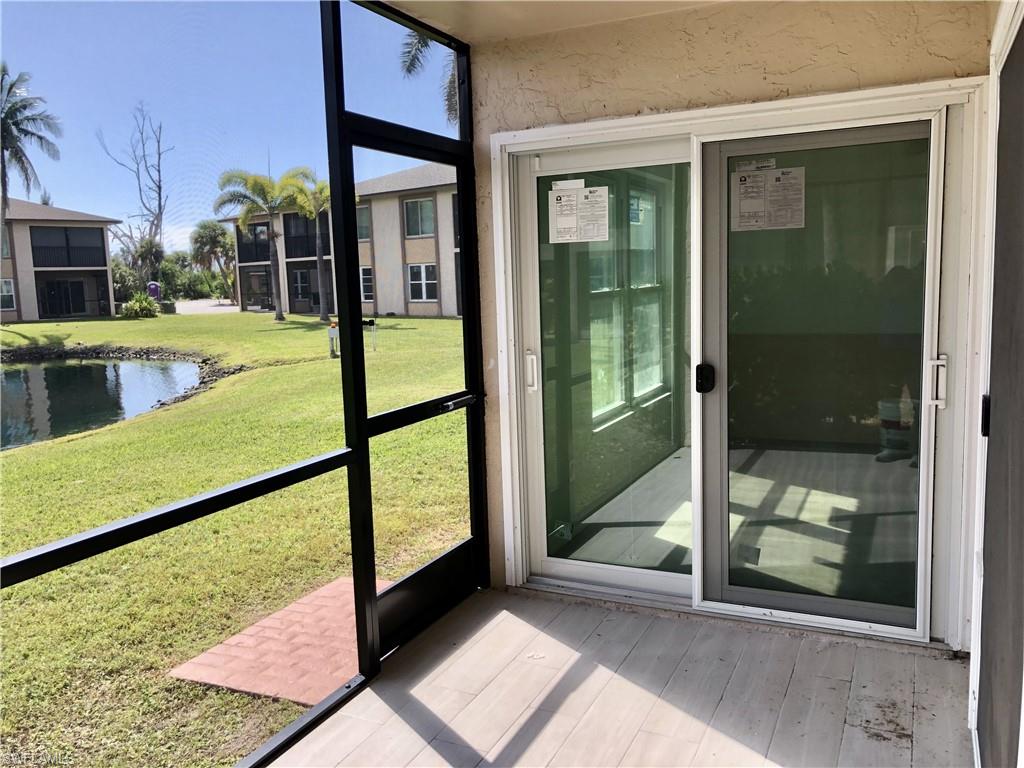 Screened patio with wood-finish flooring and direct access to the exterior