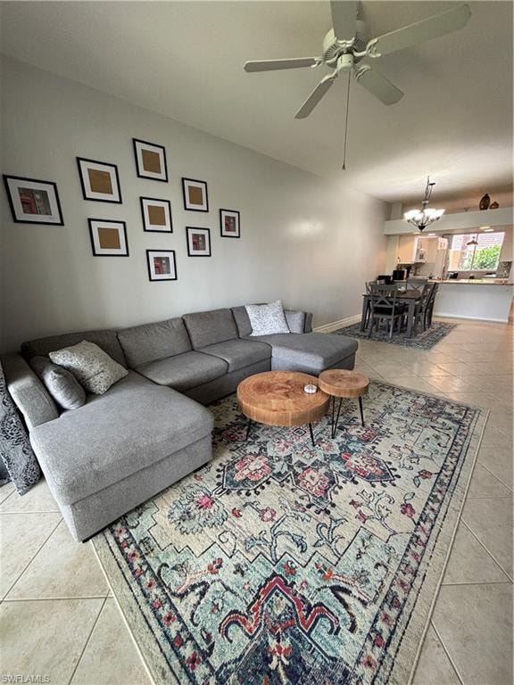 Spacious living area featuring tile flooring, a high ceiling, and an overhead ceiling fan