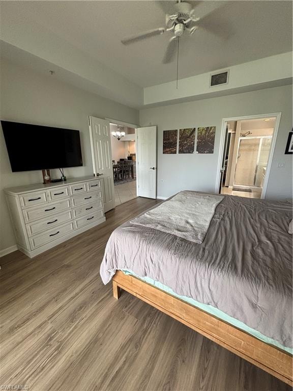 Spacious bedroom featuring wood-finish flooring, a ceiling fan, and high ceilings