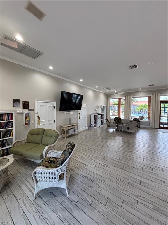 Clubhouse area with plenty of natural light, wood finished floors, crown molding, and recessed lighting
