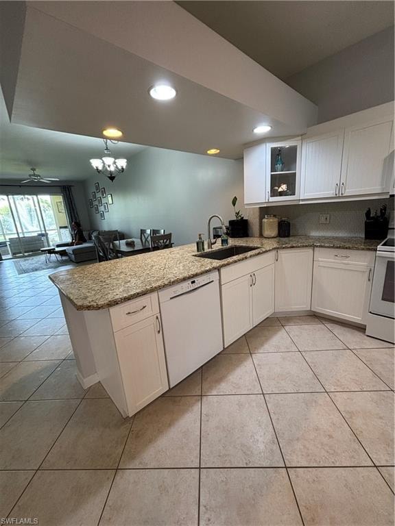Kitchen featuring white cabinetry, light granite-finish countertops, and a stainless steel sink with a dark faucet
