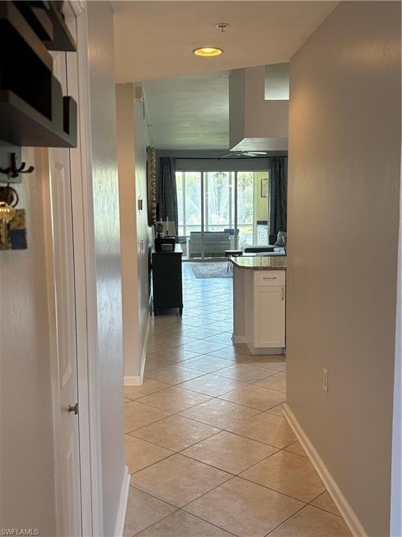 Tiled entryway featuring recessed lighting and a built-in storage closet