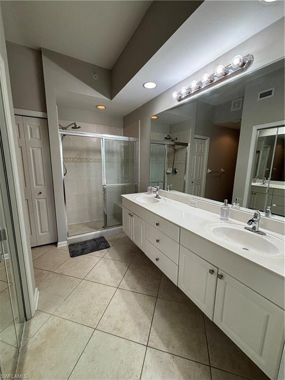 Dual vanity featuring white cabinetry, integrated sinks, and polished chrome fixtures