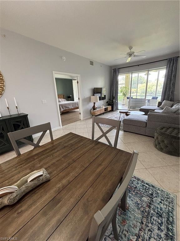 Open-concept living area featuring light-toned tile flooring throughout