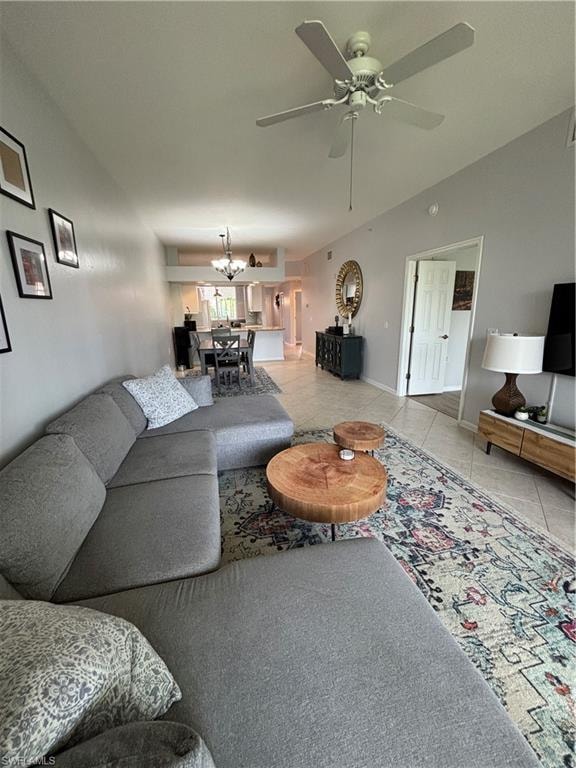 Spacious living area featuring light-toned wall paint and an overhead ceiling fan