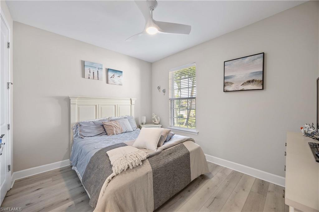 Bedroom with light wood-style floors and ceiling fan