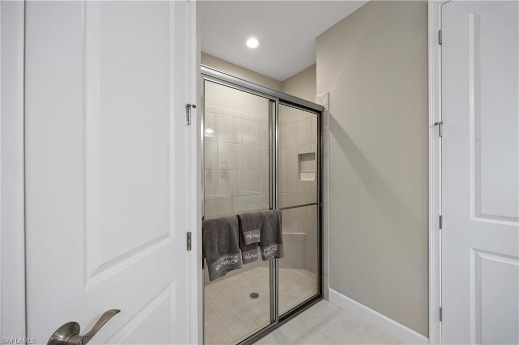 Bathroom featuring a shower stall, light tile patterned flooring, and recessed lighting