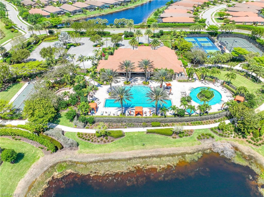 Aerial perspective of suburban area with a large body of water and a pool