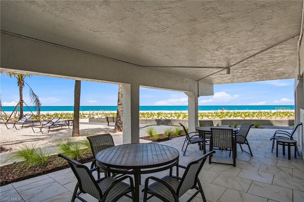 Covered patio featuring large format tile flooring and direct beach access