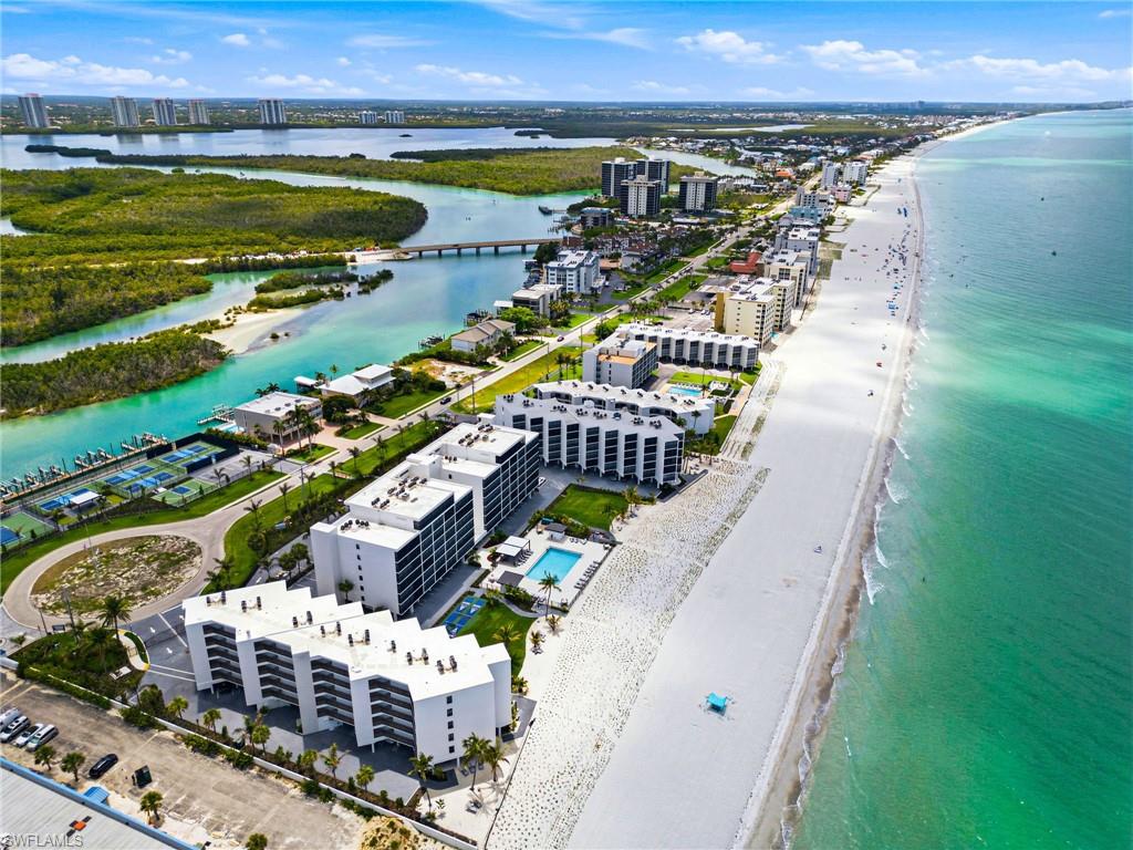 Coastal property featuring beach frontage, white sand, and clear turquoise waters