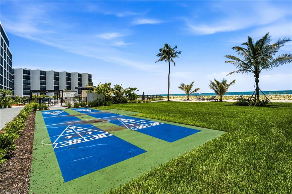 Shuffleboard court with a green border and blue playing surface