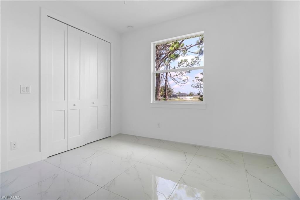 Bright interior space featuring large format marble-look tile flooring