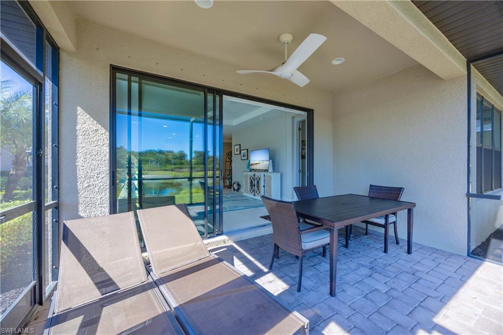 Sunroom featuring outdoor dining area, ceiling fan, a patio, and healthy amount of natural light
