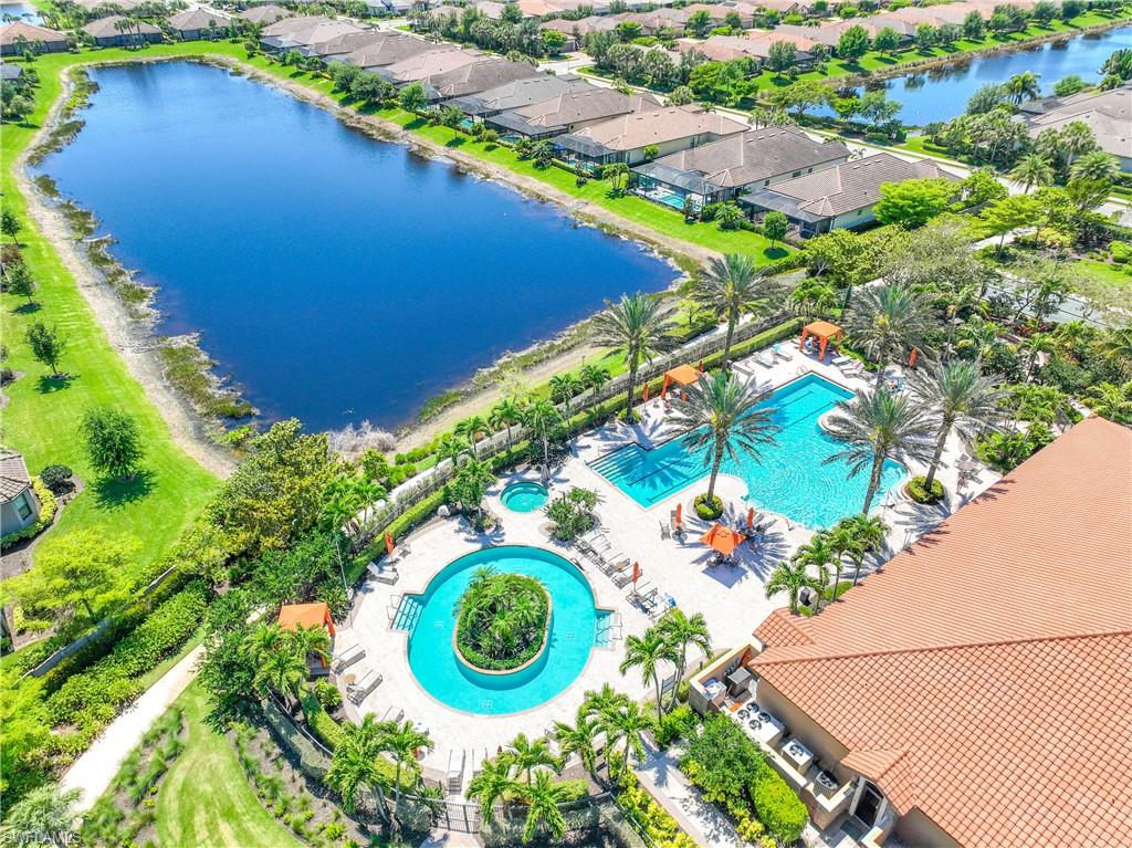 Aerial view of residential area featuring a nearby body of water