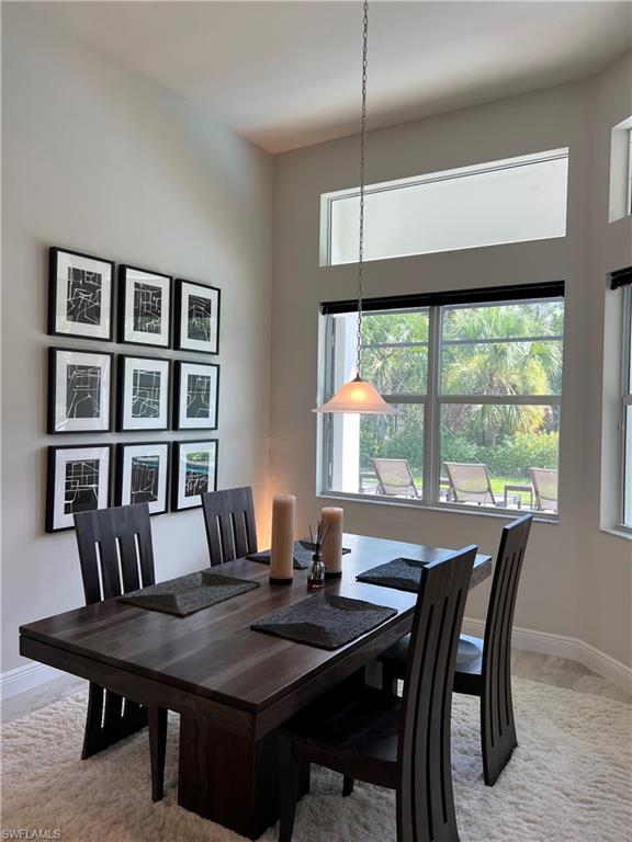 Vaulted ceiling with transom windows, featuring a pendant light fixture