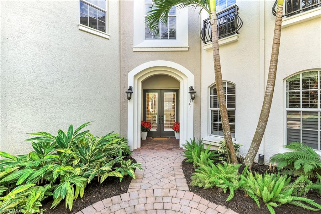 Private front entry with lush landscaping.