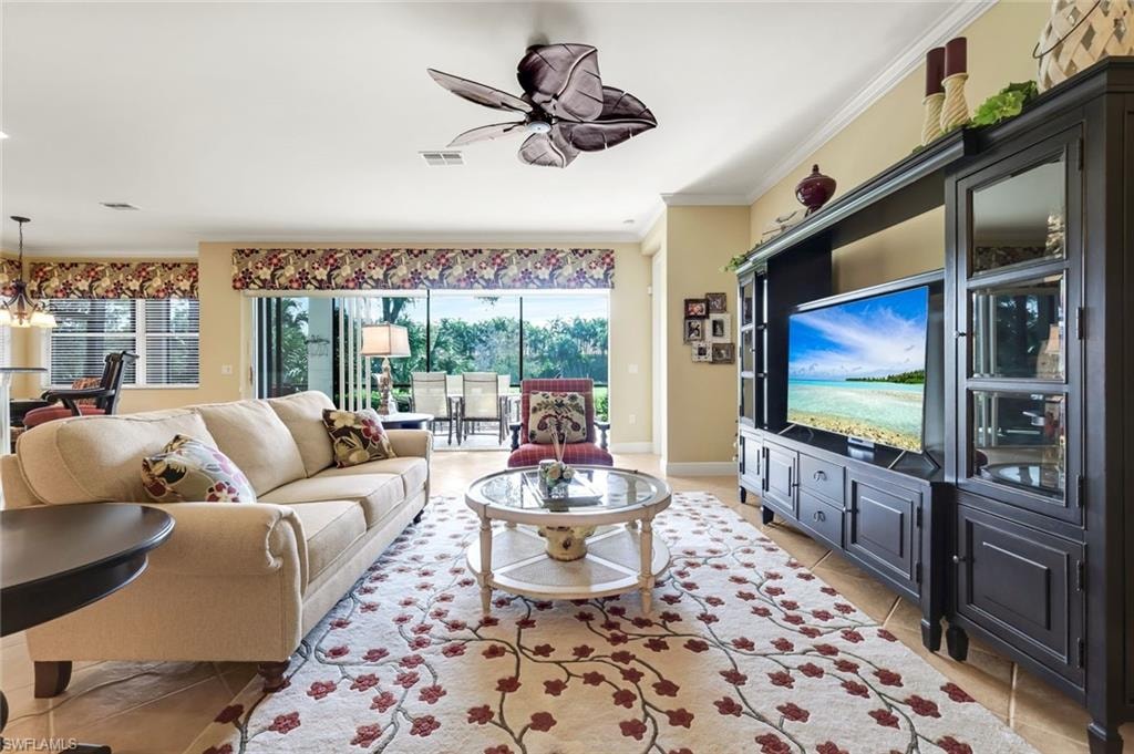 Living room with designer finishes including custom cornice boards, matching pillows and rug.