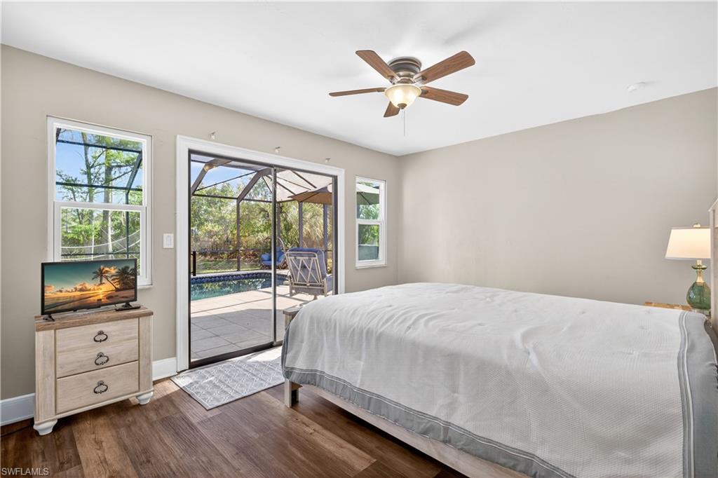 Bedroom featuring wood-finish flooring, neutral wall paint, and a ceiling fan with light fixture